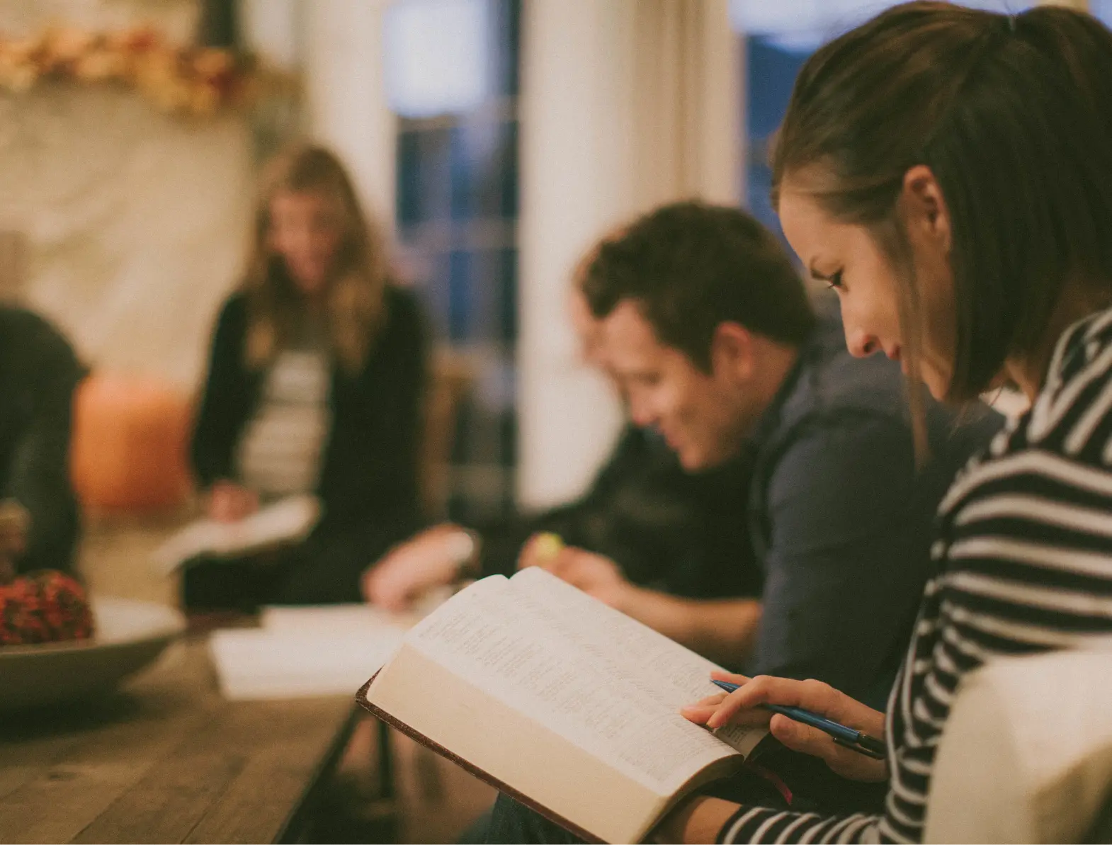 Group reading book in small setting